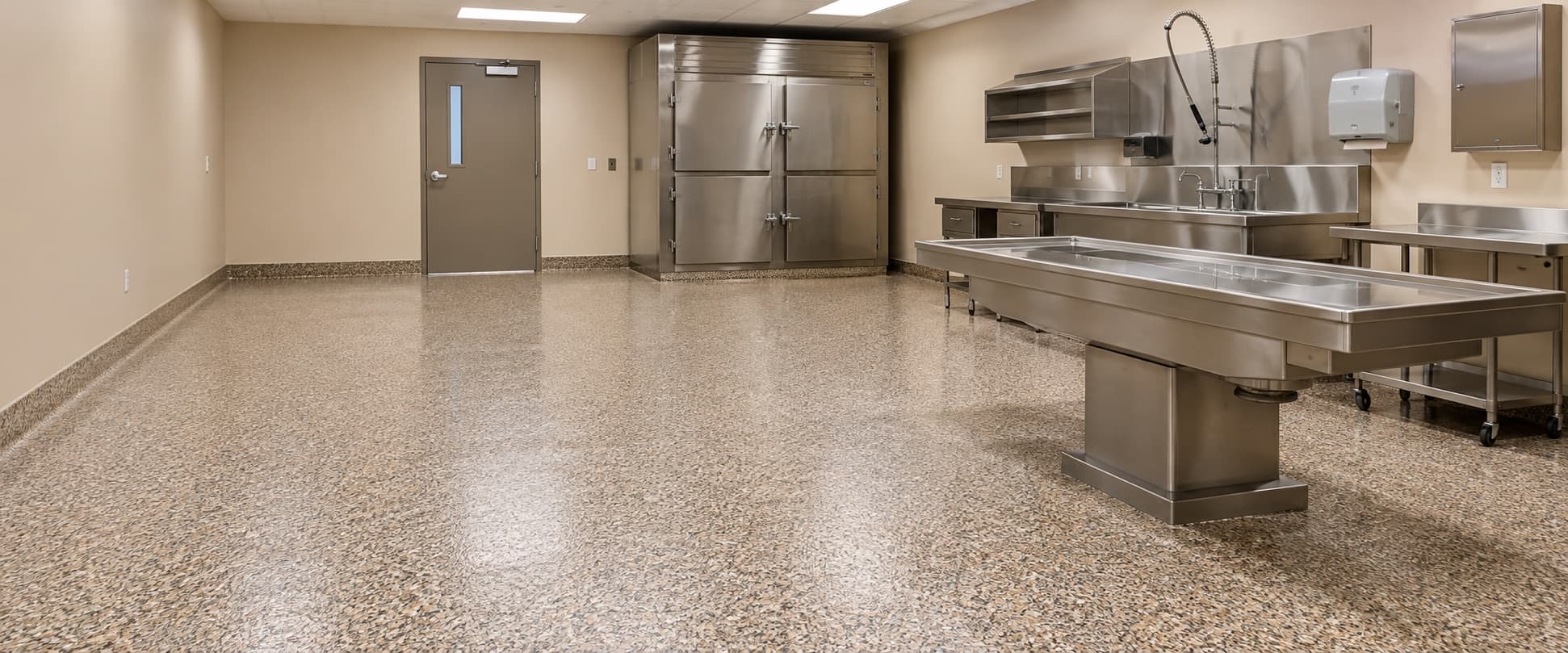 Clean, seamless floor in a bright mortuary preparation room