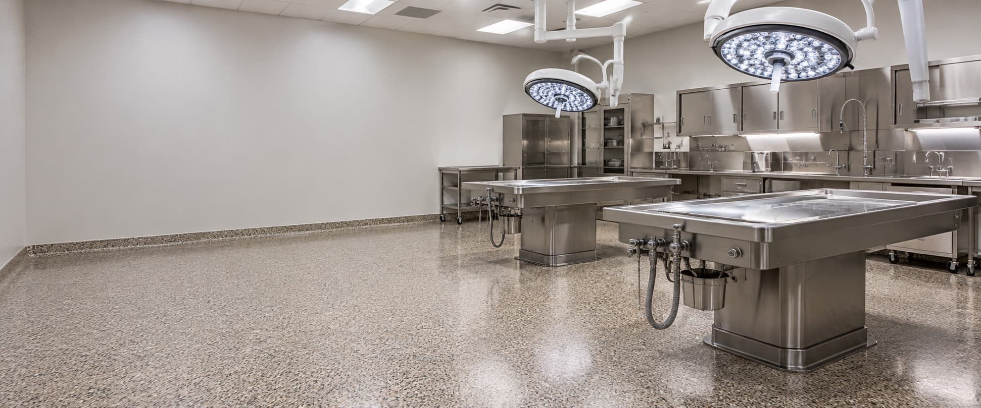Empty, spotless autopsy suite with a seamless floor