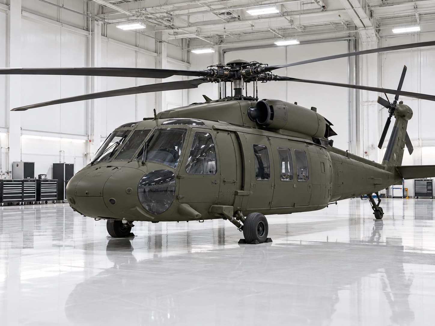 Utility helicopter parked on a glossy hangar floor